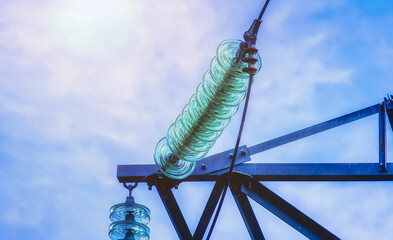 High-voltage tower wires. The insulator of the transmission line in close-up.