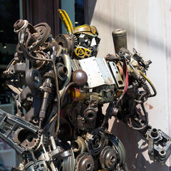 Robot made of metal parts and assemblies. Metal components and parts are arranged in shape of a robot.