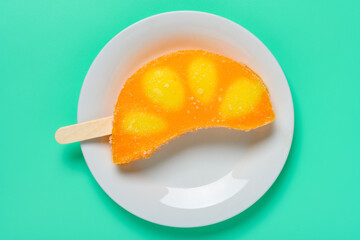 top view fresh orange shape and flavor popsicle on a plate