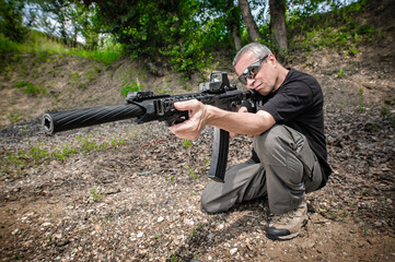Front view gun point of rifle machine gun. Firearm shooting and tactical weapons training. Outdoor shooting range