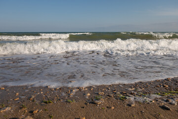 Picturesque sea landscape, wave white foam. Natural waves and beach.