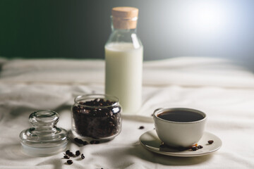 Black coffee and coffee beans on the table in the morning