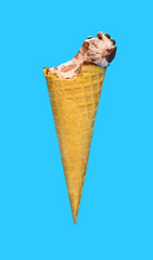 side view fresh chocolate flavor ice cream cone with a bite on a blue background