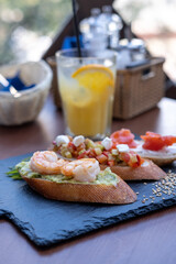 Bruschetta with shrimps, vegetables, salmon. Restaurant snacks.