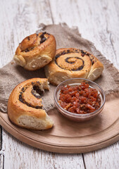 Tasty buns with raisins on a white rustic wooden table. fresh bakery. breakfast. bread. top view
