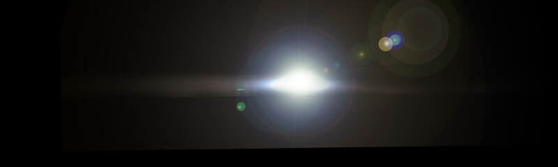 Abstract lens flare light over black background.