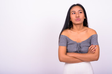Obraz premium Young beautiful Asian woman against white background