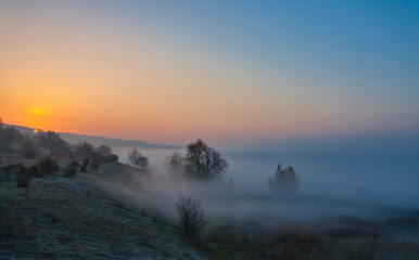 Beautiful foggy autumn sunrise landscape.