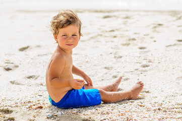 Cute boy having fun on beach.
