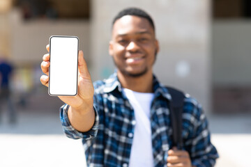 Afro man showing blank mobile phone screen