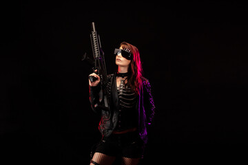 Young woman dressed in a studded leather jacket, a pair of cyberpunk glasses, holding an assault rifle in her hands