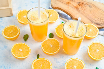 orange juice in a glass, top view, slices of oranges, straw, healthy lifestyle concept