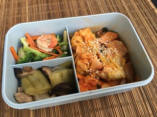 This lunch set includes Stir Fried Pork dumplings with Kimchi Sauce and  vegetable fried and bitter melon soup