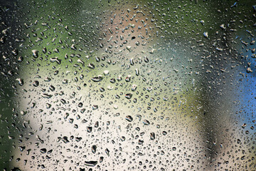 Fototapeta na wymiar Drops of water perched on my window glass
