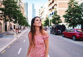 Beautiful young fashionable woman in sexy stylish dress posing in the city with standing on the road