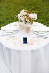 Engagement. Romantic dinner. Festive table setting with an engagement ring, proposal to get married.