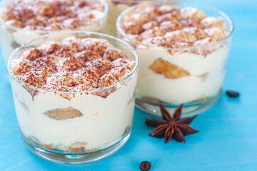 classic Italian dessert tiramisu in glasses, decorated with cocoa powder