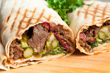 Wraps with marinated beef and pickles.