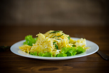 fried omelet with thin vermicelli with salad leaves in a plate