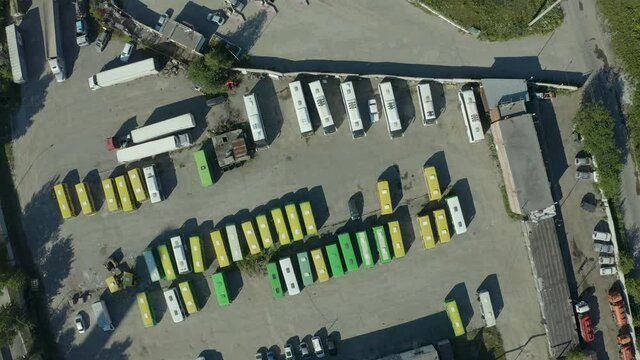 Camera flight over a parking lot with cars, trucks and buses. Automotive industry is important source of CO2 emissions.
