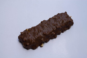 Delicious chocolate bar on white background