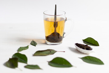 herbal tea with fermented cherry leaves on white background