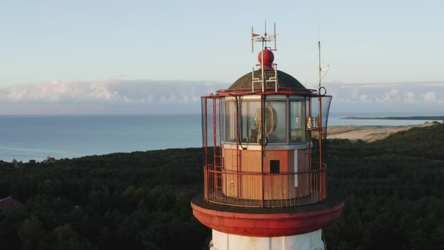 Aerial view of lighthouse top in early morning sunrise light. Shot near Nida town in Curonian spit national park, Lithuania.