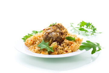 boiled bulgur groats with vegetables and meatballs in a plate