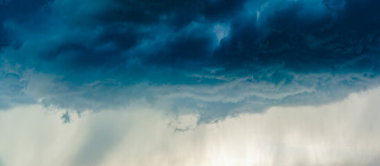 Dramatic stormy clouds, close up view on a fluffy cumulus before storm. - obrazy, fototapety, plakaty
