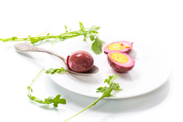 marinated chicken eggs in beetroot marinade in a plate
