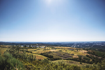 overhead view of landscape of sown fields against blue sky