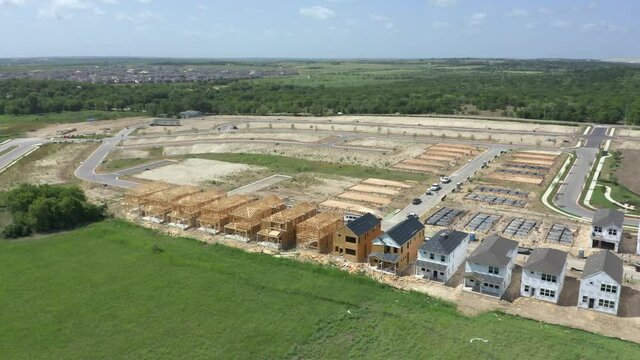 Aerial View of Austin Texas subdivision under construction show many partially completed suburban homes, housing development under construction