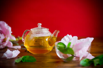 summer flower tea from rose petals in a glass teapot