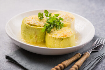Roasted round zucchini stuffed with minced meat, vegetables, and cheese