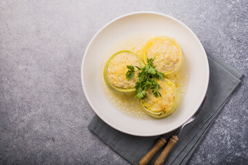 Roasted round zucchini stuffed with minced meat, vegetables, and cheese