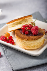 Close up Fluffy Soufflé Japanese pancake recipe with berry. Trendy asian food for breakfast.