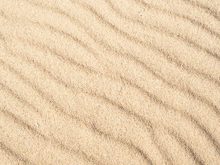 Fototapeta na wymiar Summer vacation texture. Close up sand wave dune background