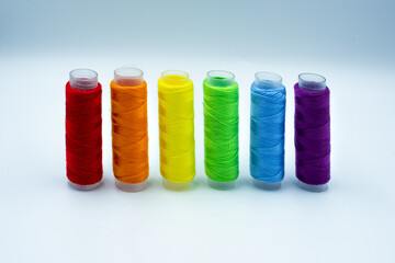 Rainbow made of colourful thread spools isolated on a white background. Lgbt and love symbol. Lesbian, gay, bisexual, transgender community rights support concept.