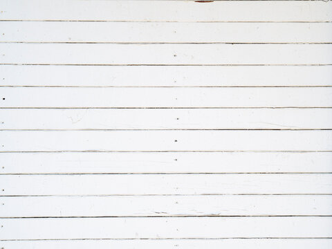 Old white wooden planks background. Texture of old boards with peeling paint