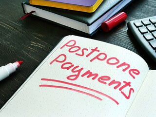 Postpone payments red memo on the page and calculator. Deferment or Forbearance concept.