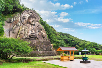Side angle view of the largest stone-carved magaibutsu statue of giant buddha Daibutsu Yakushi of...