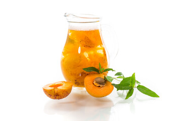 cold apricot compote in a glass decanter