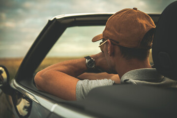 Men Behind Convertible Car Steering Wheel