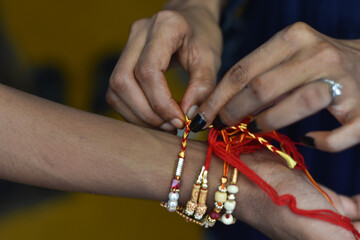 Indian sister tie a traditional rakhi in a brother hand in raksha bandhan, Indian Traditional Festival