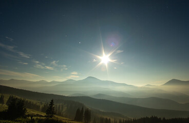 Moonlit foggy night in the mountains in summer