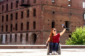 Fototapeta na wymiar A girl with disabilities at the historical monument.