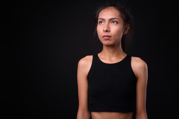 Fototapeta na wymiar Young beautiful Asian transgender woman against black background