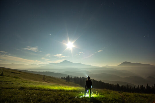 Silhouette of a man on a moonlit night in the carpathian mountains - Powered by Adobe