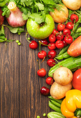 Fototapeta na wymiar Assortment of fresh vegetables and fruits on wooden table background. Healthy organic food concept