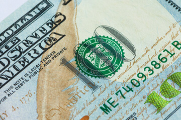 Part of a hundred-dollar bill, maximum close-up. A hundred-dollar bill is on the table. Currency Of...